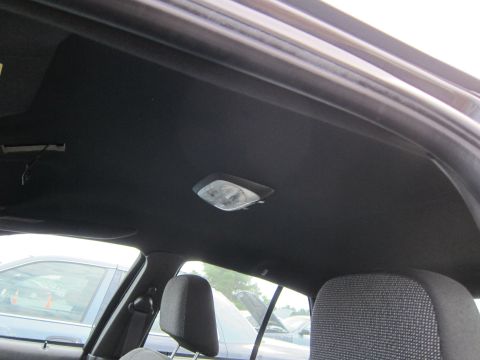 2001 Ford Crown Victoria - View of the interior headliner and dome light, with other vehicles visible through the windows.