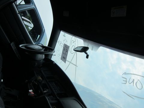 2001 Ford Crown Victoria - The interior of a vehicle is shown, with markings on the windshield and a view of the sky.