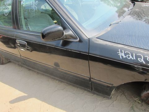 2001 Ford Crown Victoria - A black 2001 Ford Crown Victoria is viewed from the side, with visible chalk markings on the front fender.