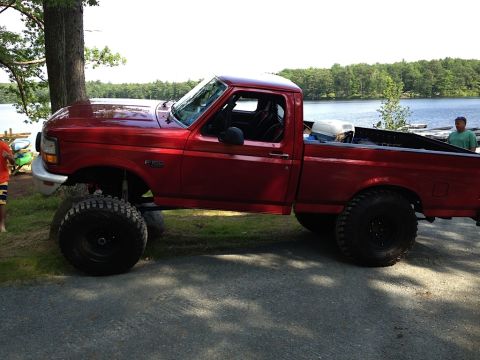 1996 Ford F-150 - This lifted 1996 Ford F-150 sits by a lake, its off-road capabilities.