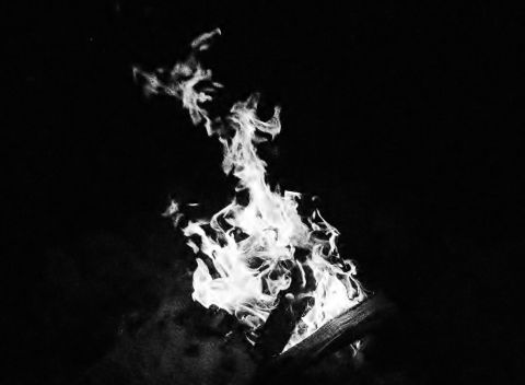 2006 Ford E350 - Flames dance and flicker in the darkness, consuming the wood fuel.