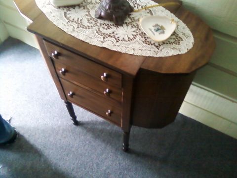2006 Ford E350 - A close-up view of an antique wooden cabinet a lace doily and a small decorative dish on its surface.