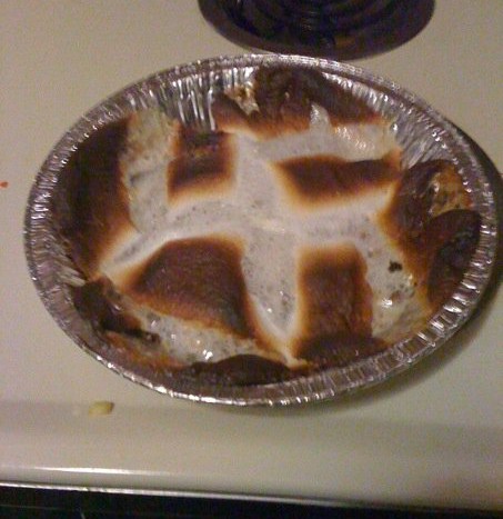 2006 Ford E350 - A baked dessert with a criss-cross pattern of toasted marshmallows sits in a foil tin.