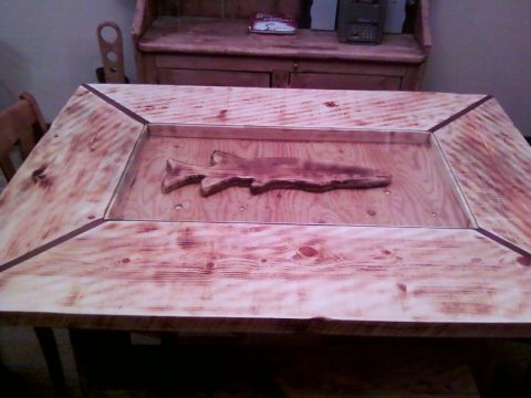 2006 Ford E350 - A wooden table features a carved fish set into its surface.