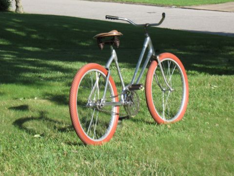 1994 Ford Bronco - A vintage-style bicycle with bright orange tires sits on a grassy lawn.