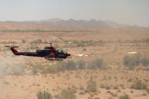 1978 Ford F-250 - A military helicopter fires missiles in a desert environment, with other projectiles visible in the distance.