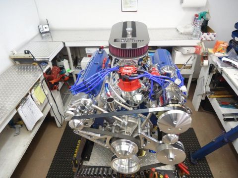 1982 Ford Bronco - Custom V8 engine on a stand, likely a performance build, in a workshop setting.
