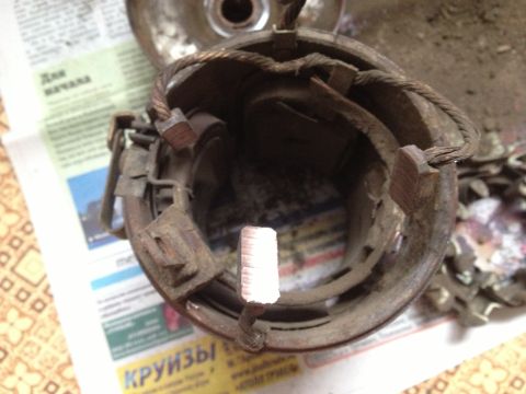 1987 Ford Bronco - This image shows a disassembled starter motor, likely from an older vehicle, with visible wear on its components.