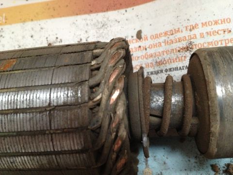 1987 Ford Bronco - Close-up of a worn starter motor armature, showing damaged copper windings and rust on metal parts.