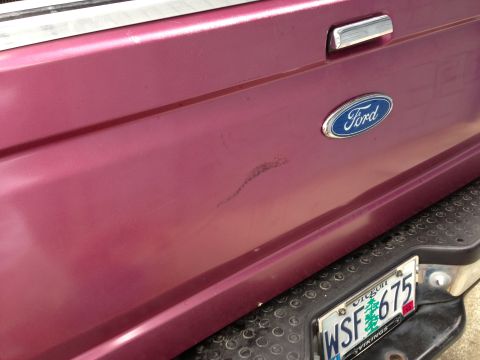 1992 Ford F-150 - Rear view of a red 1992 Ford F-150 pickup truck, showing the tailgate with a Ford emblem and Oregon license plate.