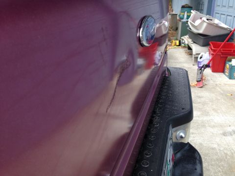 1992 Ford F-150 - Rear quarter panel of a 1992 Ford F-150 shows a dent and some rust.