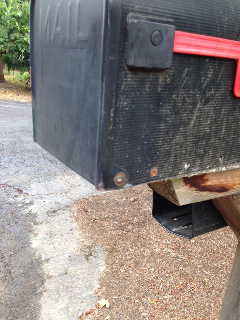 1992 Ford F-150 - A black mailbox with the word "MAIL" embossed on its side is mounted on a wooden post.