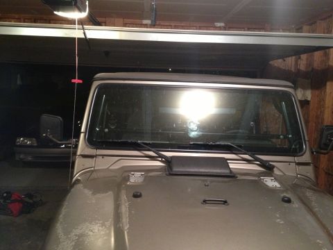 2005 Jeep Wrangler - Front view of a 2005 Jeep Wrangler parked in a garage with another vehicle in the background.