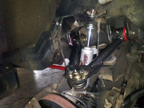 2003 Nissan Frontier - Close-up view of front suspension parts, possibly from a truck or SUV.