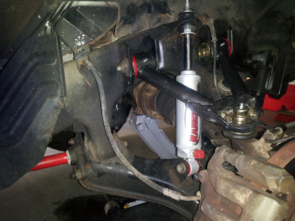 close-up of front suspension with new shock absorber and red sway bar