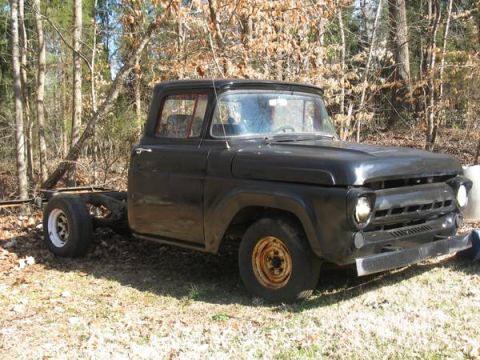 1957 Ford F-100 - This 1957 Ford F-100 truck is missing its rear end and bed, sitting in a wooded area.