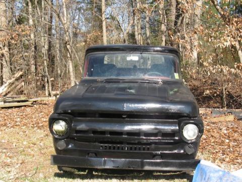 1957 Ford F-100 - Front view of a black 1957 Ford F-100 pickup truck parked outdoors.