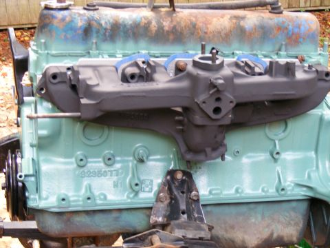 Engine block with intake manifold, light green paint, some rust on top
