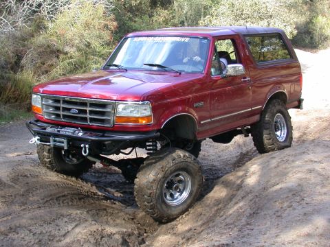 1996 Ford Bronco - This modified Ford Bronco is shown off-road with its lifted suspension and large tires.