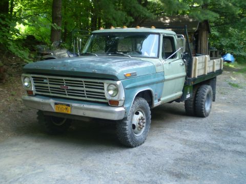 1979 Ford Bronco - This Ford F-Series truck features a flatbed and dual rear wheels, with a grille indicative of a 1967 model year.