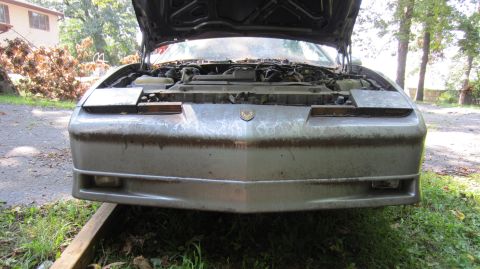 1987 Pontiac Firebird - Front view of a 1987 Pontiac Firebird with its hood open, revealing the engine bay.