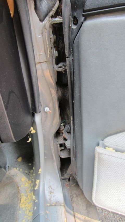 1987 Pontiac Firebird - Close-up view of the door jamb and interior panel of a vehicle, showing wear and tear.