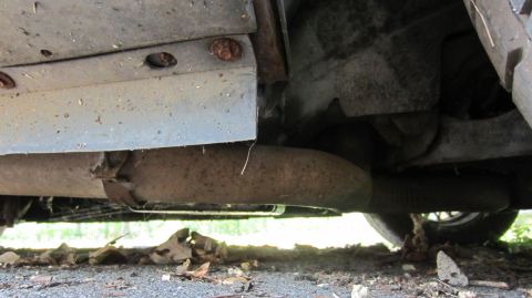 1987 Pontiac Firebird - Close-up of the undercarriage, showing the exhaust pipe and suspension components.