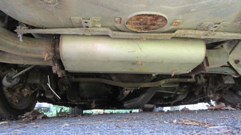 1987 Pontiac Firebird - The underside of a vehicle, revealing its exhaust system and suspension parts.