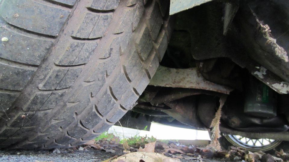 Undercarriage view of a tire and suspension components