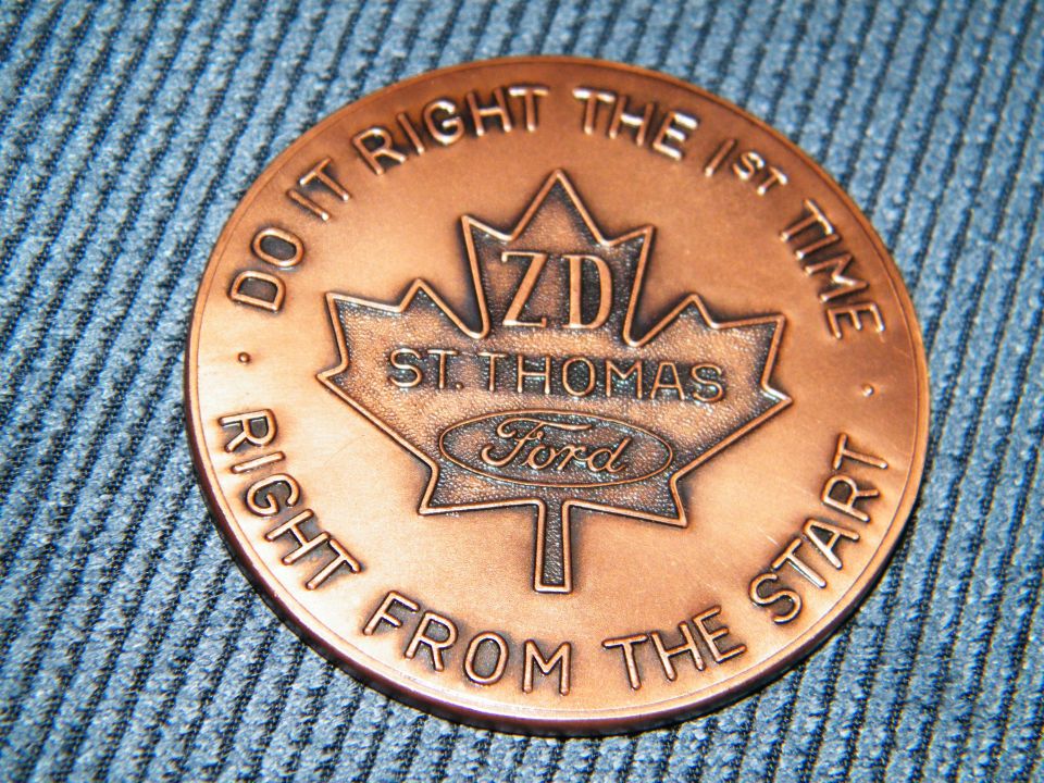 Copper coin with ZD St. Thomas Ford logo and text 'DO IT RIGHT THE 1ST TIME RIGHT FROM THE START'