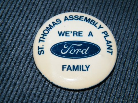 2004 Ford Crown Victoria - A Ford assembly plant pin is shown against a textured blue background.