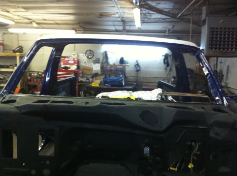 1982 Ford Bronco - The front section of a 1978 Ford Bronco is visible, partially disassembled in a garage setting.
