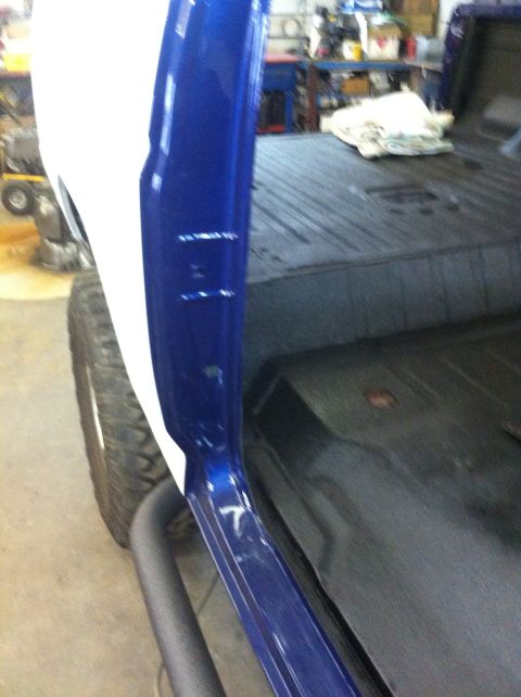 1982 Ford Bronco - Close-up of a vehicle's interior, highlighting the blue and white paintwork and floor.