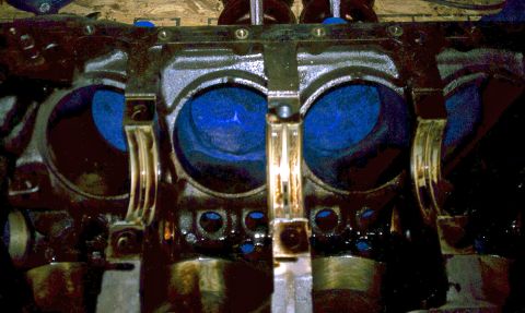 1996 Ford Bronco - Close-up view of an engine block showing blue-coated pistons and connecting rod bearings.