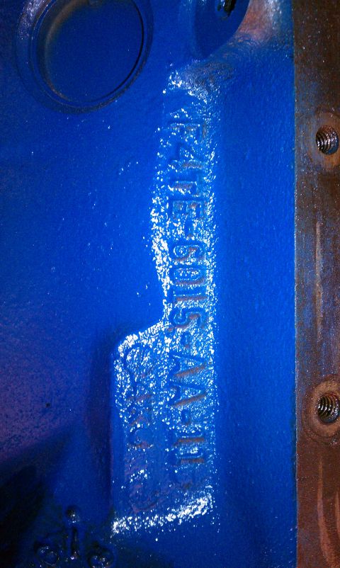 1996 Ford Bronco - Close-up of a blue engine block casting showing a stamped serial number.