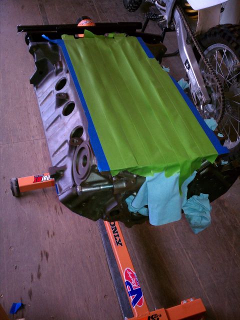 1996 Ford Bronco - Engine block on a stand, prepped with tape and cloths for work.