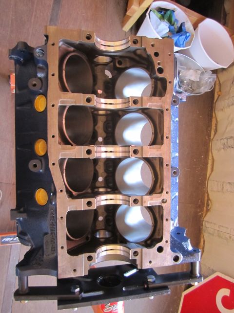 1996 Ford Bronco - Engine block with cylinder bores and bearing caps visible. Part number F4TE-6015-MA-10 is stamped on the side.