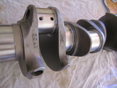1996 Ford Bronco - A close-up view of a SCAT crankshaft, identified by markings, with polished journals and cast counterweights.