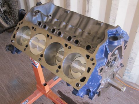 1996 Ford Bronco - Engine block with pistons visible, mounted on an orange engine stand.