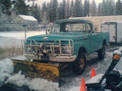1963 Ford F-250 - Turquoise 1963 Ford F-250 pickup truck equipped with a front-mounted snow plow and brush guard.