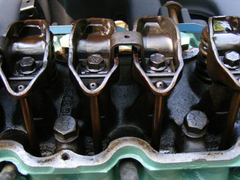 Close-up of engine valve train with rocker arms and pushrods visible