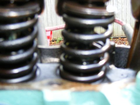 Close-up of engine valve springs with Supermotors.net logo