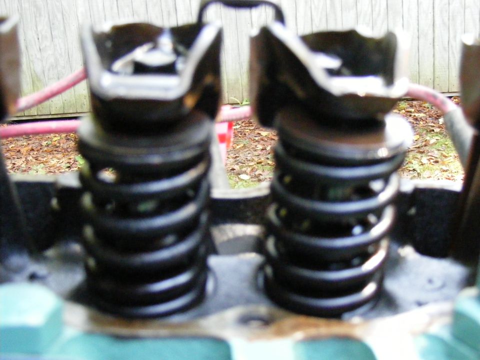 Close-up of two engine valve springs and their retainers