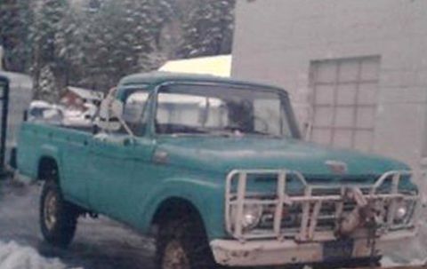 1963 Ford F-250 - A teal pickup truck from 1961 is parked outside a building with snow on the ground.