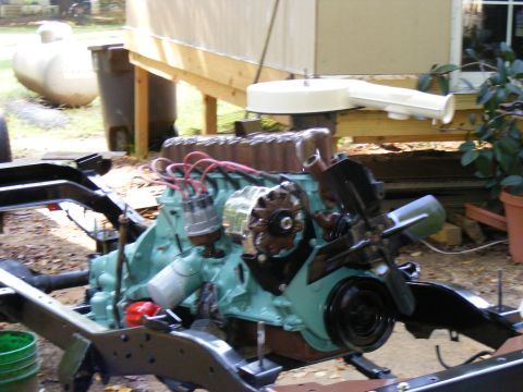 Teal engine on a black chassis with red spark plug wires
