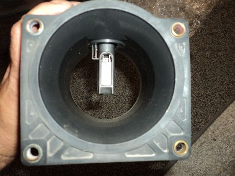 2004 Mercury Grand Marquis - A person is holding a mass air flow sensor, showing its internal components.