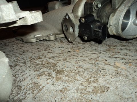 2004 Mercury Grand Marquis - Close-up of a vehicle throttle body and sensor assembly.