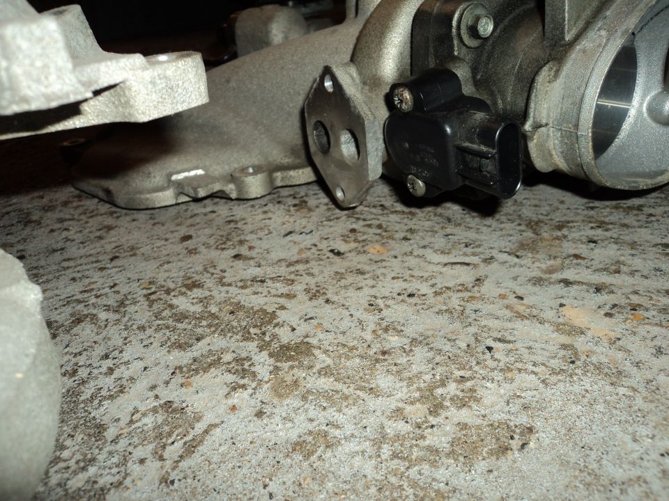 Throttle body with attached sensor on concrete floor