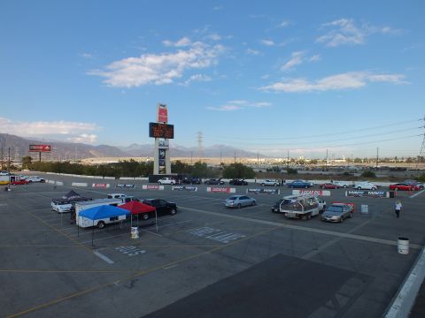 2003 Ford Crown Victoria - Elevated view of an automotive event lot with vendor tents, Lucas Oil and MAVTV banners, and a tall Toyota pylon sign.