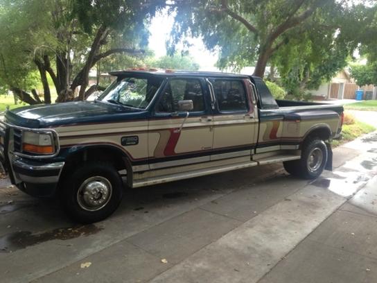 Ford F-350 crew cab dually pickup truck, tan and dark green two-tone paint with stripes